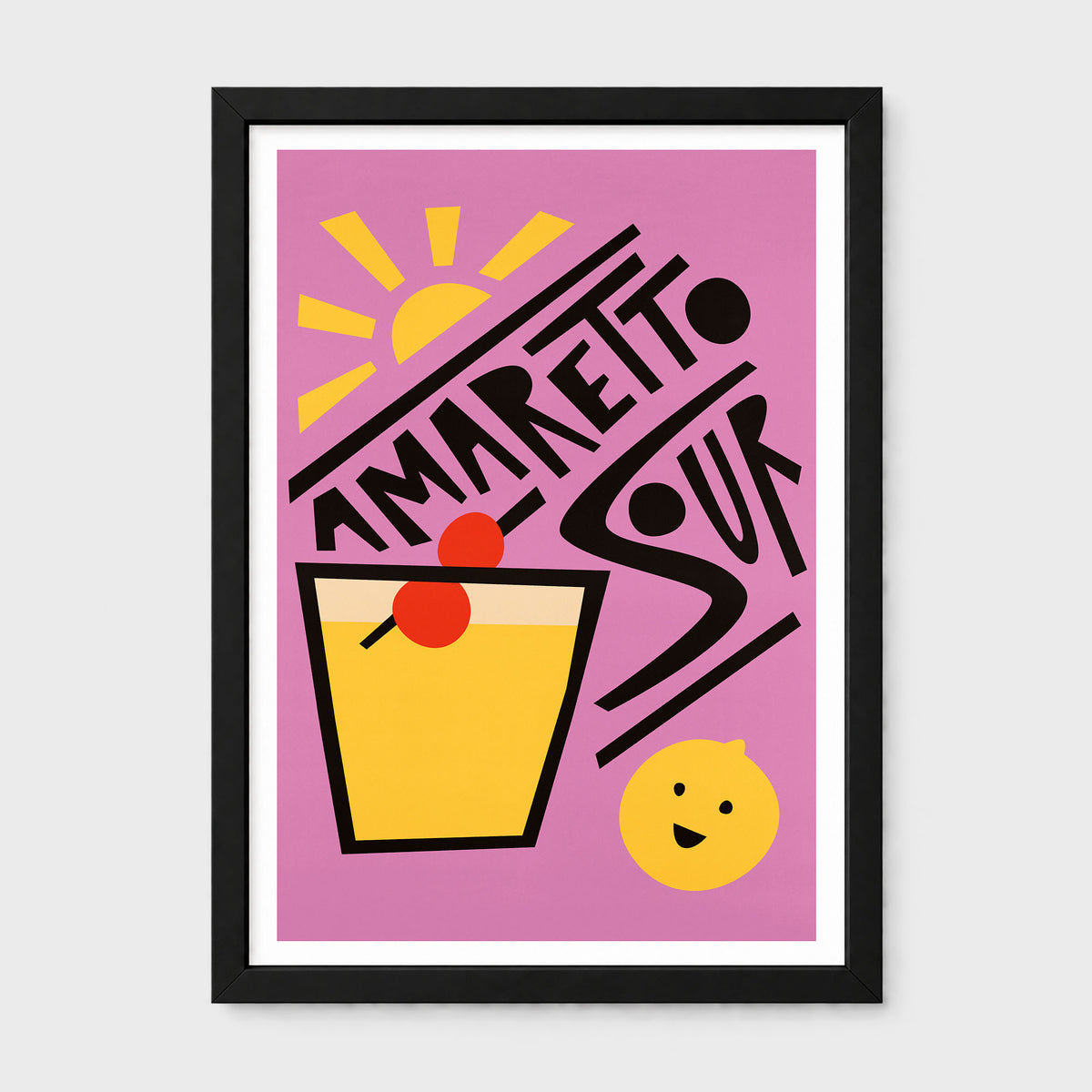 A framed art print featuring a retro-style illustration of an Amaretto Sour cocktail. The design has a pink background with a yellow sun, a yellow drink glass with red cherries, and bold black text spelling 'AMARETTO SOUR'.