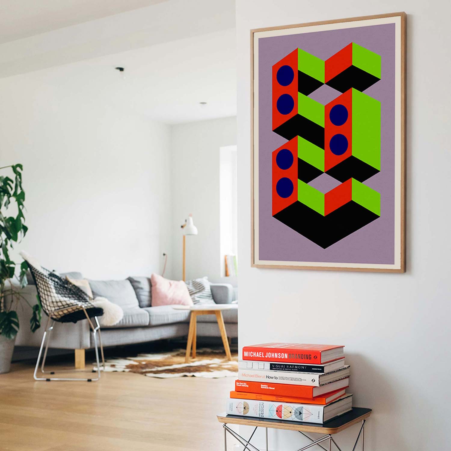 Geometric abstract art print on a wall above a chair