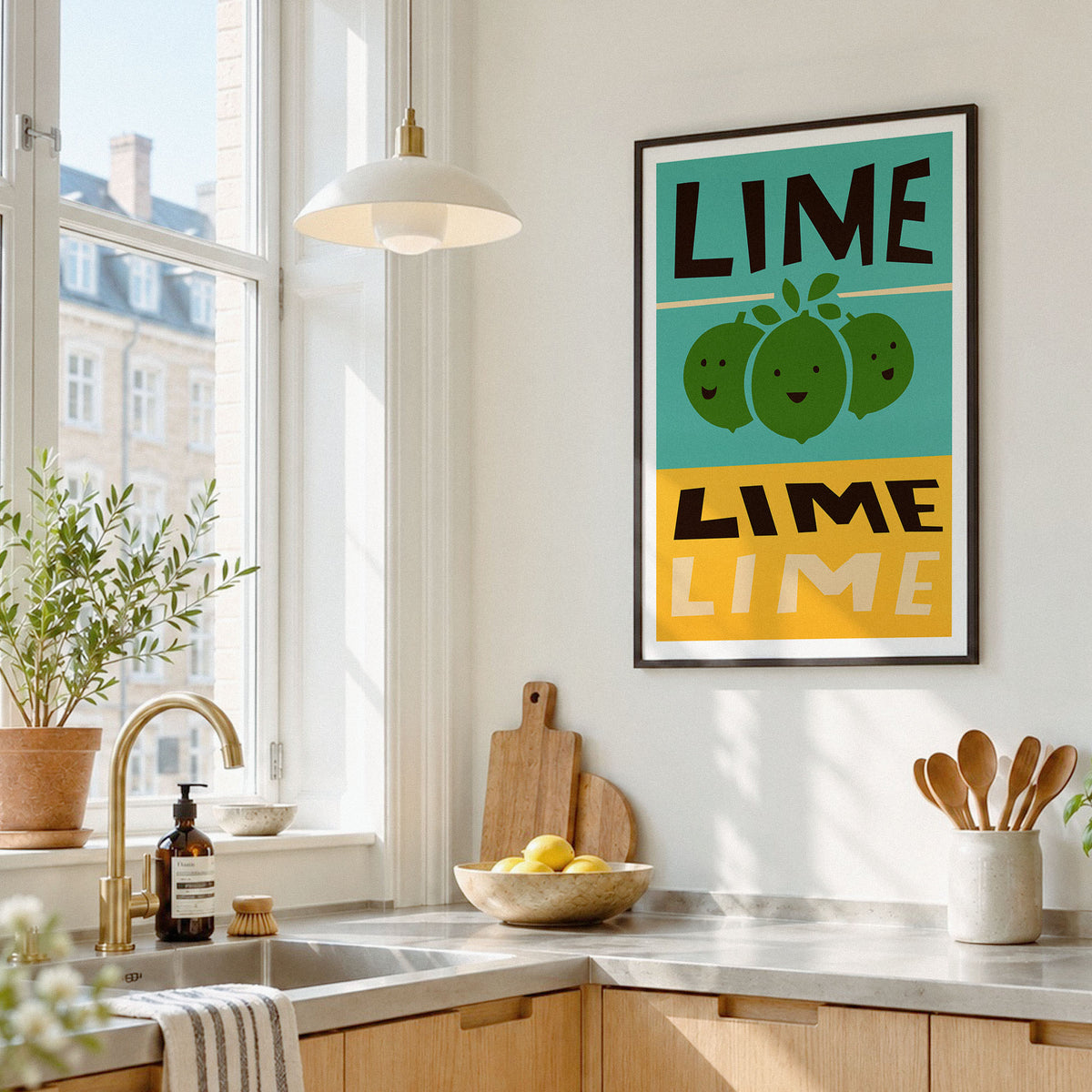 A framed wall art print featuring the word 'LIME' in black and white block letters above and below a stylized green lime illustration, displayed in a bright modern kitchen.