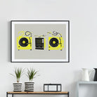 DJ decks art print hanging above a white console table with potted plants and black decor