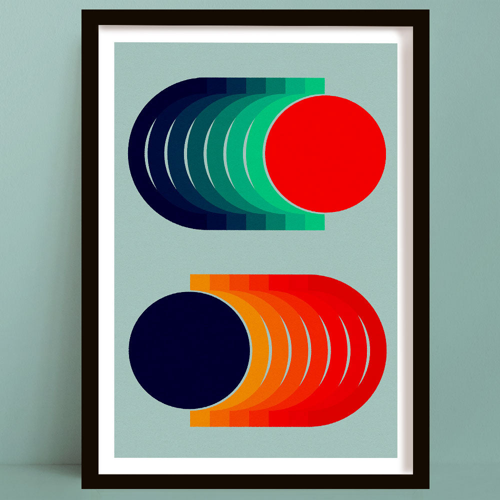 Framed abstract geometric wall art print featuring colorful isometric shapes on a light blue background, shown hanging against a matching light blue wall.