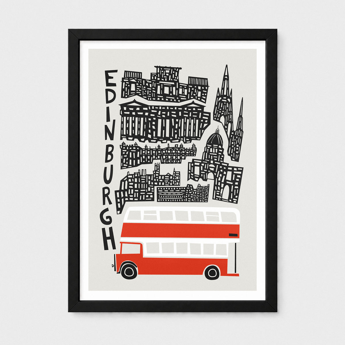 A framed art print featuring a stylized black line drawing of Edinburgh landmarks and the word 'EDINBURGH' vertically, with a red and white double-decker bus at the bottom, shown against a light gray background.