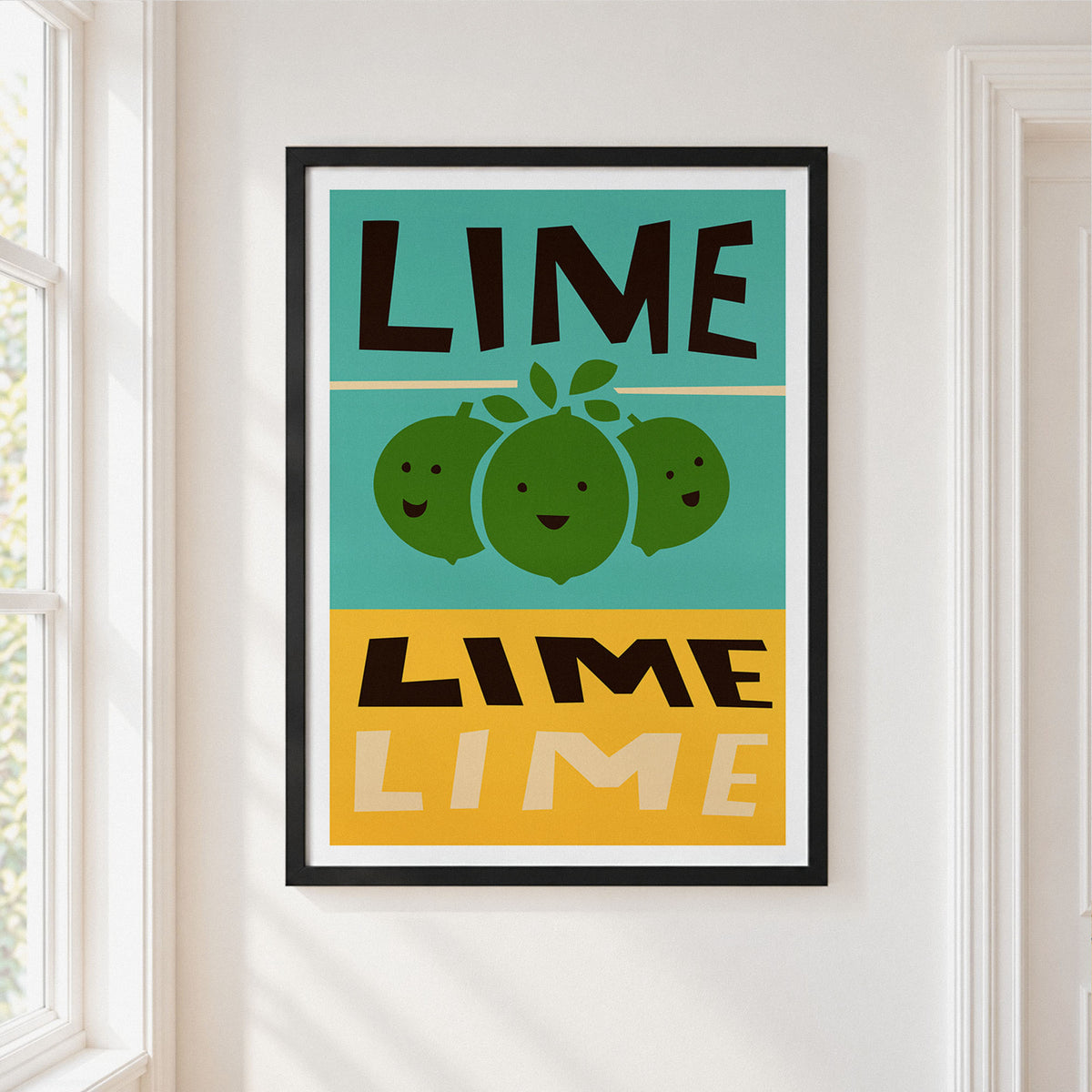 A framed art print featuring a retro-style lime illustration with the word 'LIME' in bold black letters on a teal and mustard yellow background, hung on a white wall next to a window.