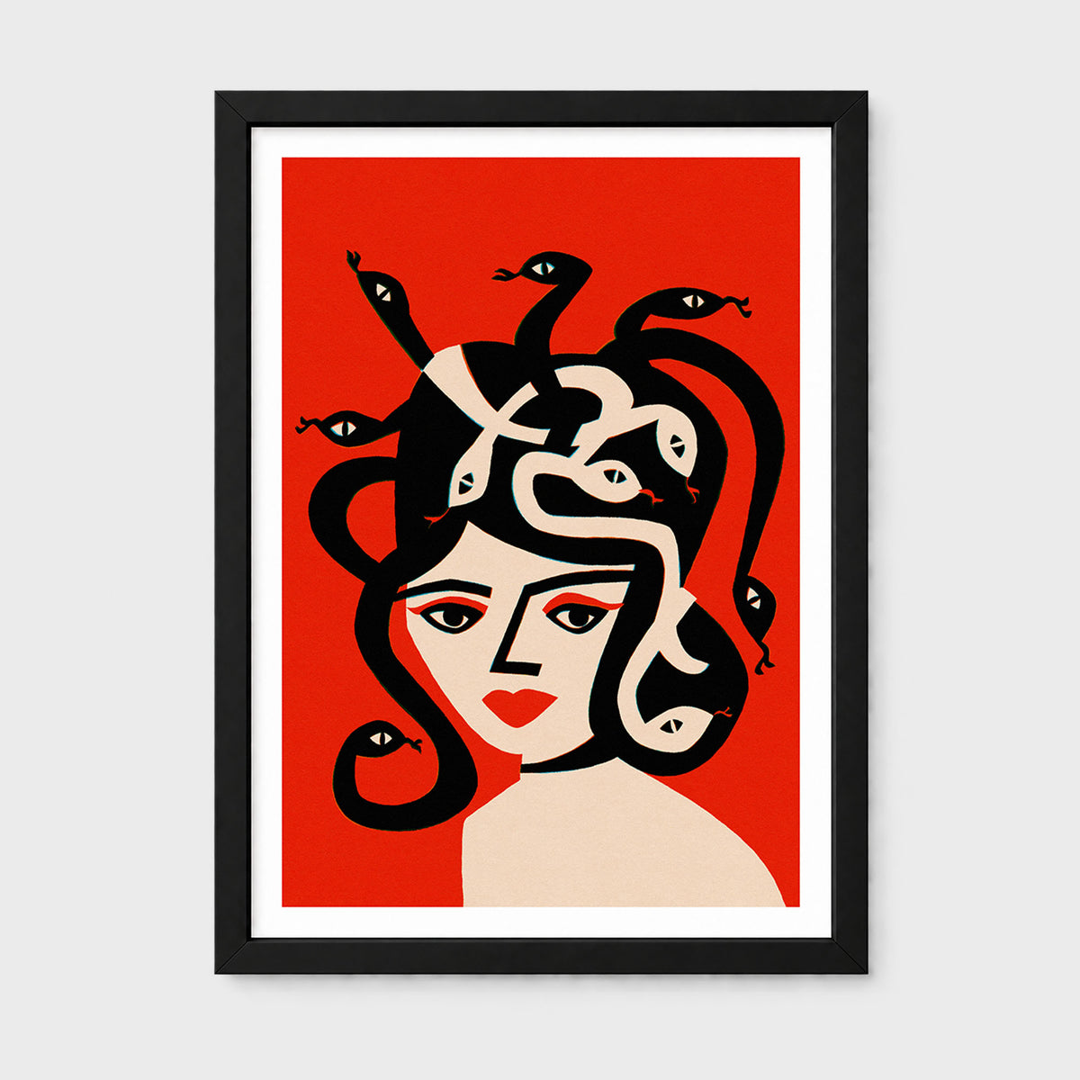 Framed art print featuring a stylized illustration of Medusa with black snakes winding through her hair, set against a bold red background with a black frame and white mat.