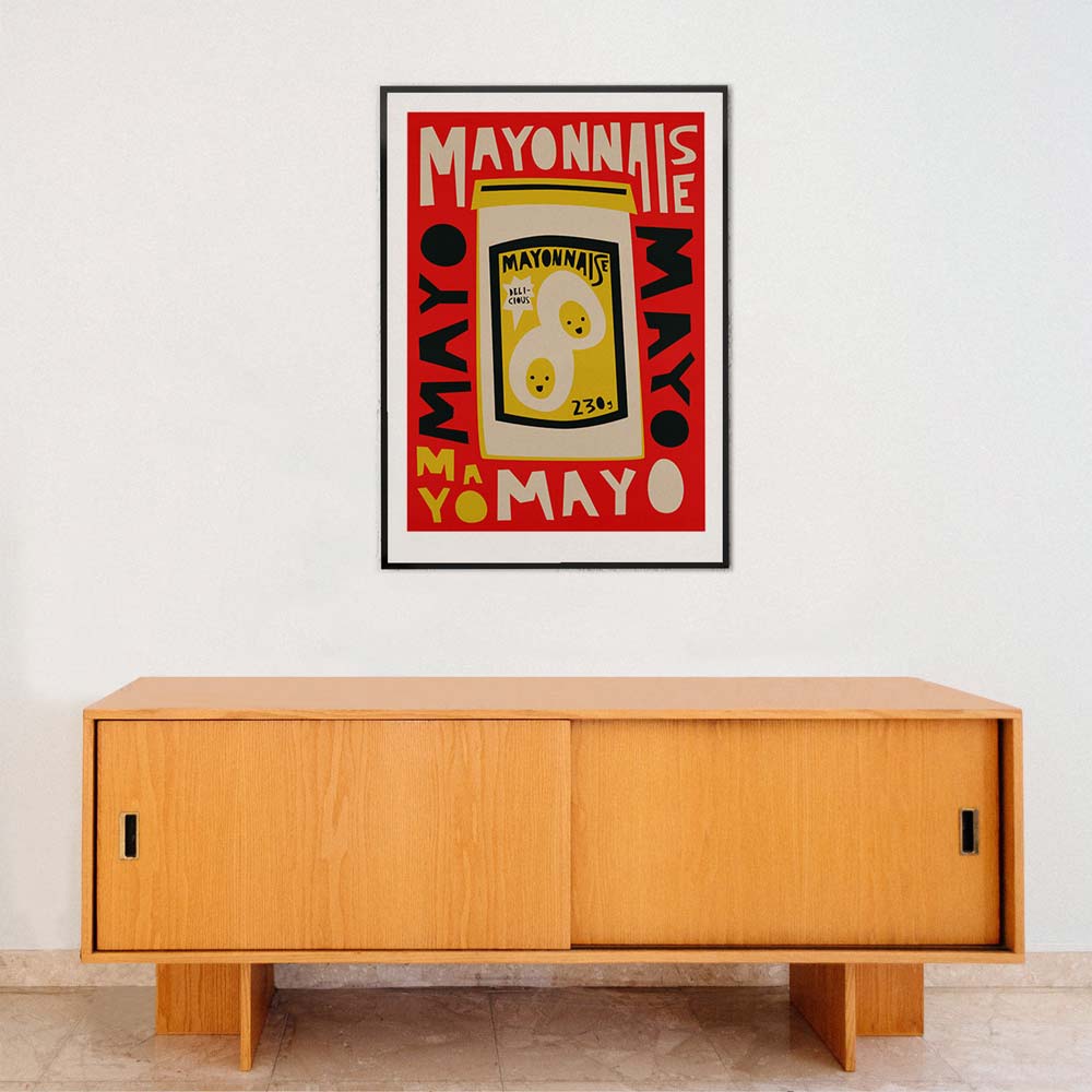 Wooden cabinet with a framed poster of a vintage mayonnaise can on a white wall.