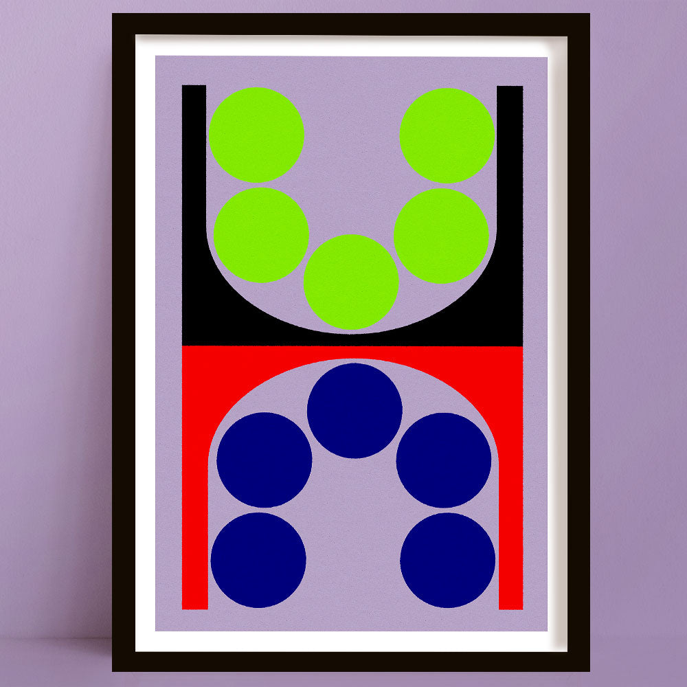 Framed abstract art print with red, pink, green, and black circles on a light blue background