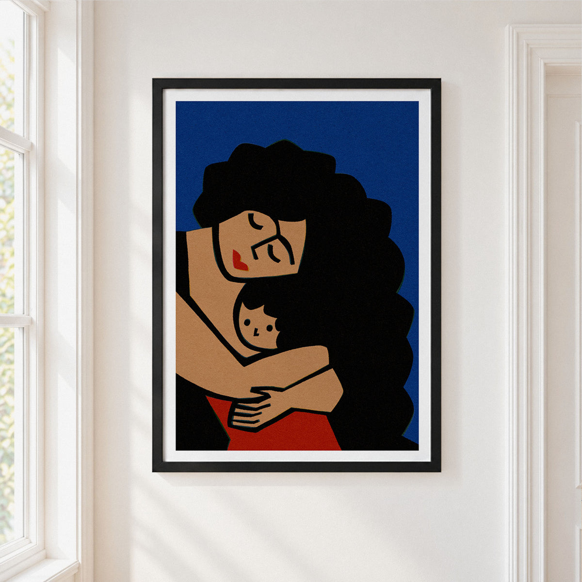 A framed art print depicting a mother and child in a minimalist, retro illustration style, hung on a white wall next to a window.