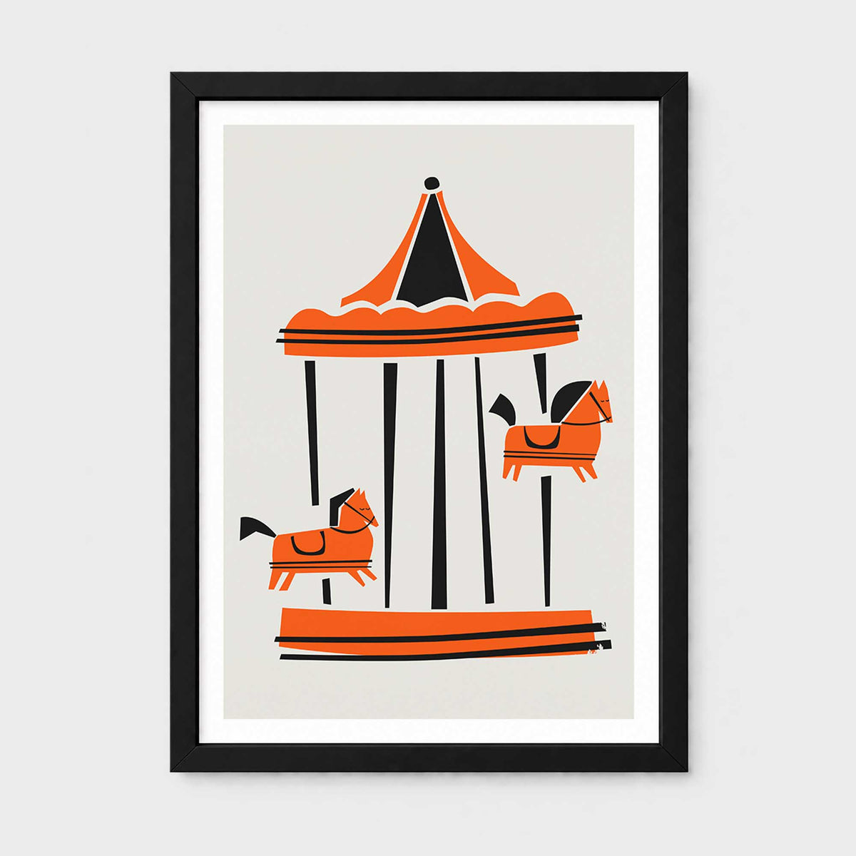 Framed wall art featuring a Parisian carousel illustration in orange, black, and cream, shown in a black frame against a light gray background.