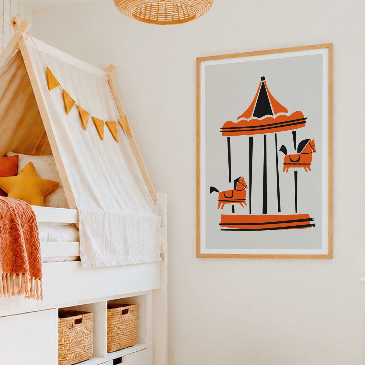 A framed art print of a Parisian carousel illustration hanging on a cream wall in a child's bedroom next to a white canopy bed with yellow accents.