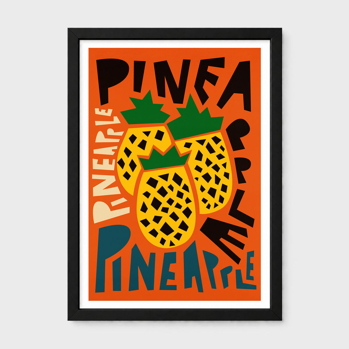 A framed art print featuring a retro-style illustration of three yellow pineapples with green tops on an orange background, surrounded by bold black and cream text reading 'PINEAPPLE'. The print is housed in a black frame with a white mat, shown against a light gray background.