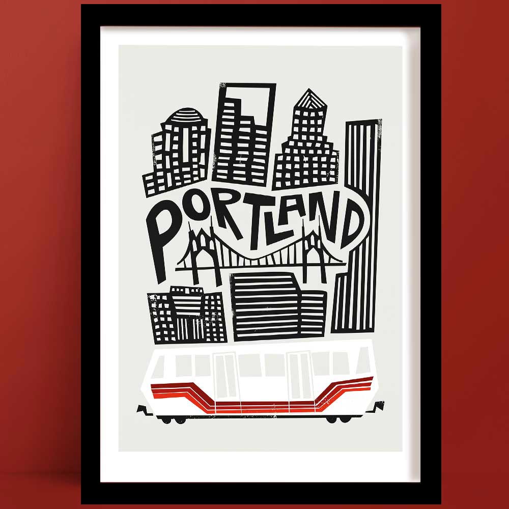 A Portland print with a bold, black and white illustration of the city's skyline, featuring iconic high-rises and the St. Johns Bridge, with a red and white streetcar below.