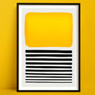 Sticks in the Sand abstract art print a bold abstract print with yellow block and black stripes, framed and set against yellow wall