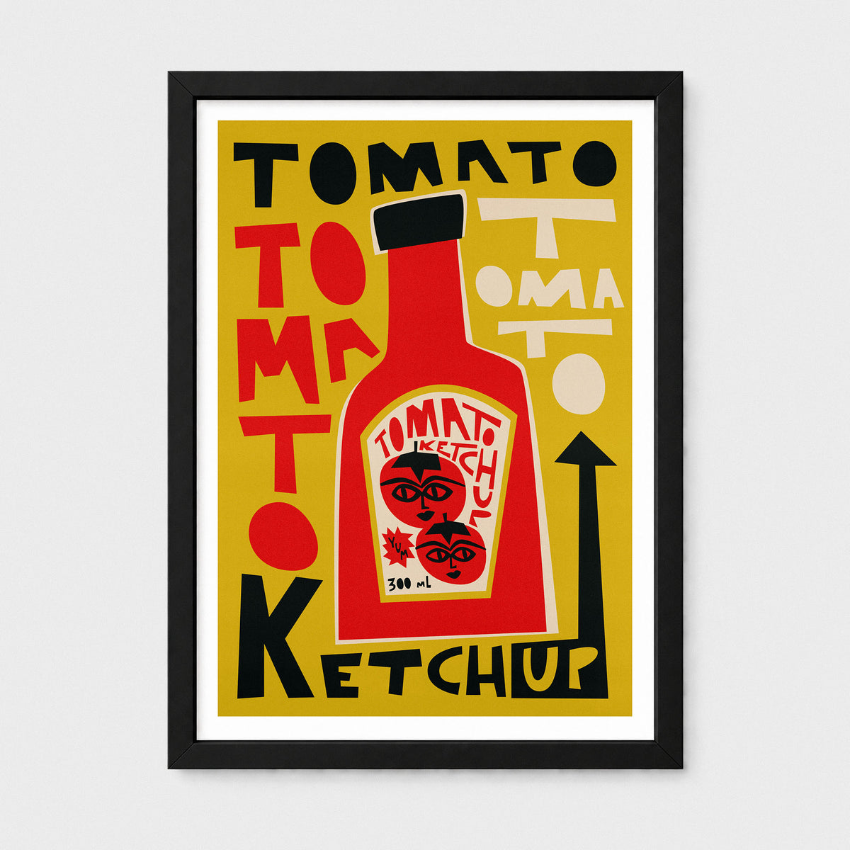 A framed graphic art print featuring a bold retro-style tomato ketchup advertisement design. The print has a mustard yellow background with a large red ketchup bottle in the center, black and red typography reading 'TOMATO KETCHUP,' and a black frame with a white mat, shown against a light gray background.