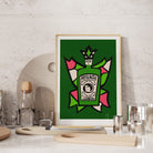 Absinthe artwork styled on a stone wall shelf with cocktail glasses and barware.