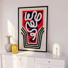 Abstract cocktail glass poster hanging in a crisp white room with soft lighting and minimal decor.
