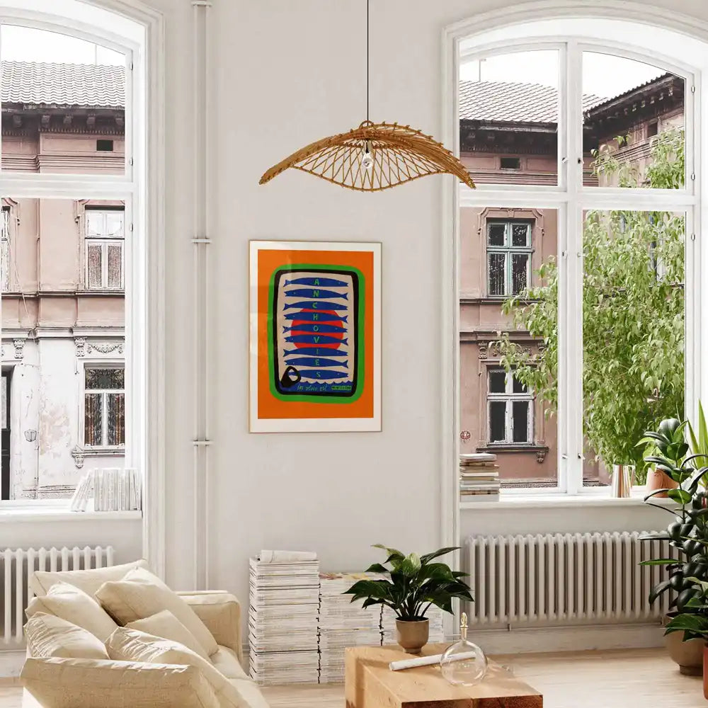 Anchovies poster hanging in bright city flat above cream sofa and indoor plants