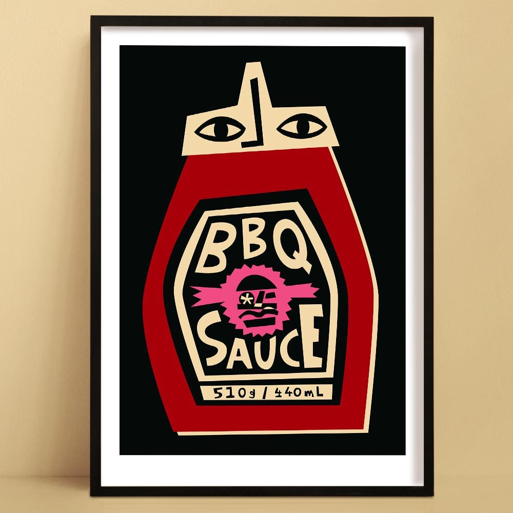 BBQ Sauce print featuring a stylised red bottle with graphic face label and bold black background, framed on beige wall.