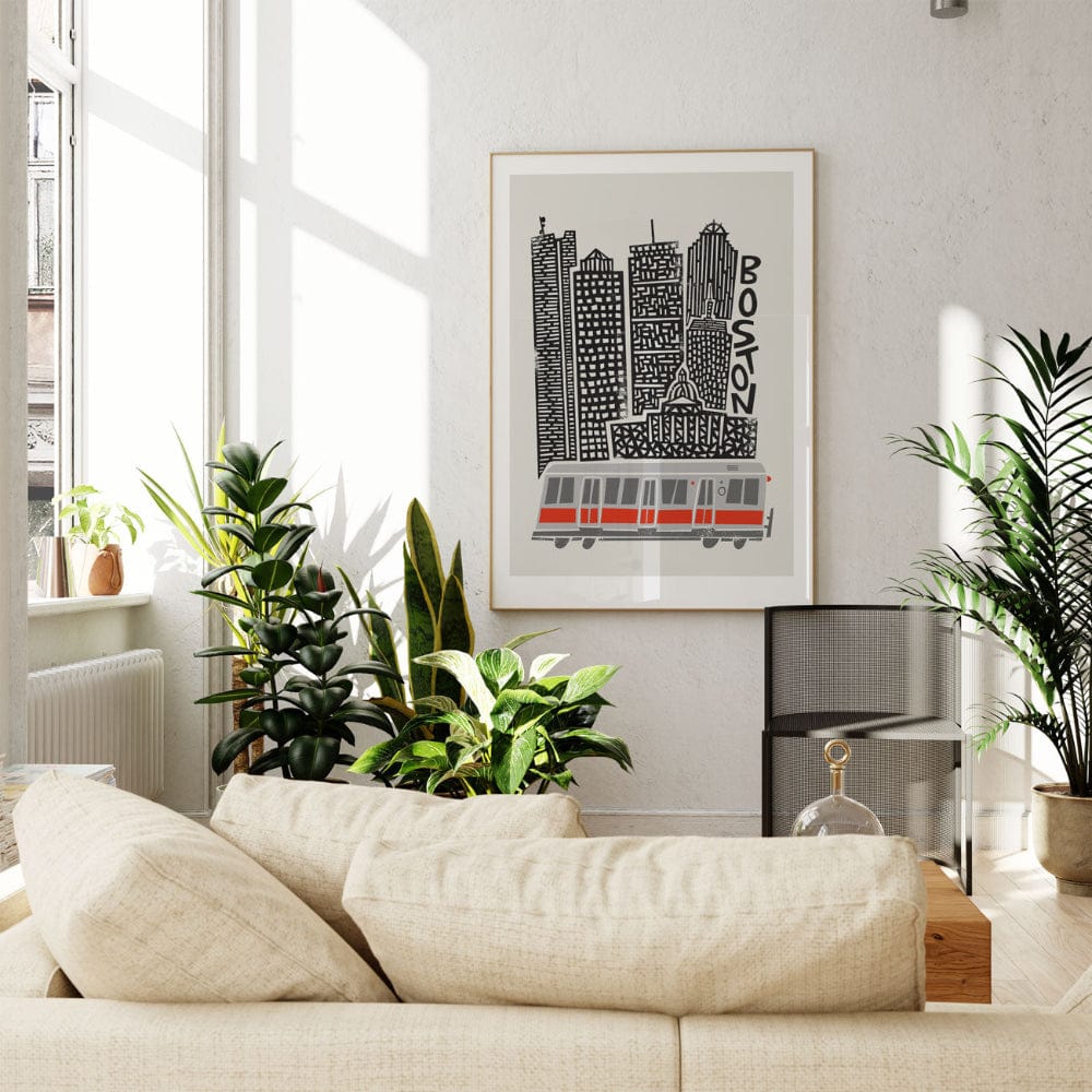 Boston city illustration displayed in a bright, plant-filled room, adding graphic charm and architectural interest to a clean modern interior.