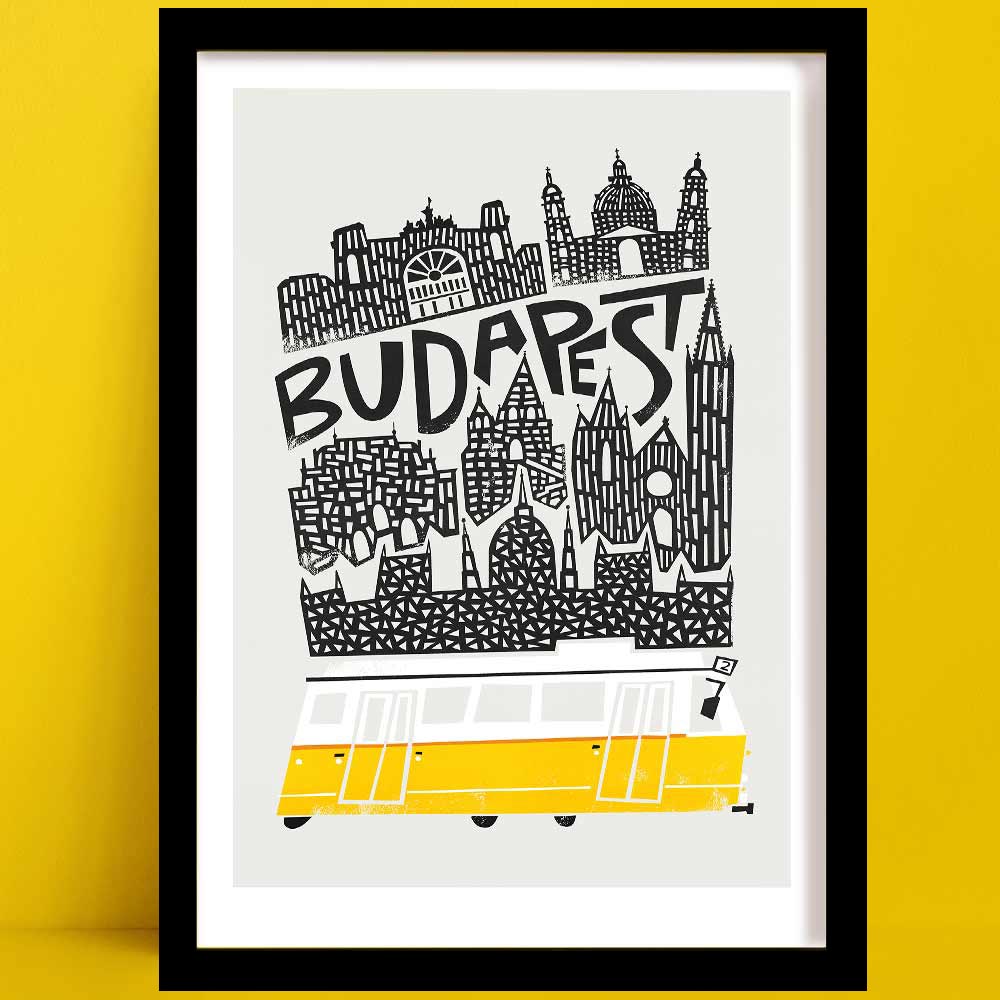 A Budapest print with a bold black-and-white illustrated skyline, featuring historic landmarks and a vibrant yellow tram at the base.