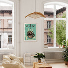 Bright and airy lounge showcasing the teal coffee print above a couch beside a large window.