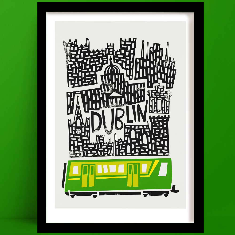 A Dublin print, in black, white and green, features famous landmarks stacked in bold linework, anchored by a bright green LUAS tram at the base of the design.