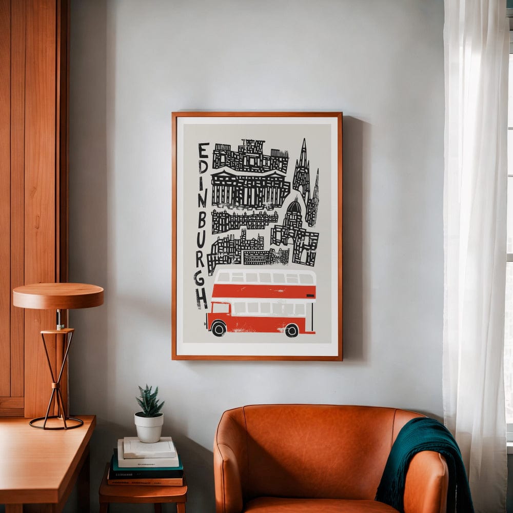 Framed Edinburgh city print with a red bus hung in a warm-toned workspace, combining vintage travel poster vibes with cosy modern interiors.