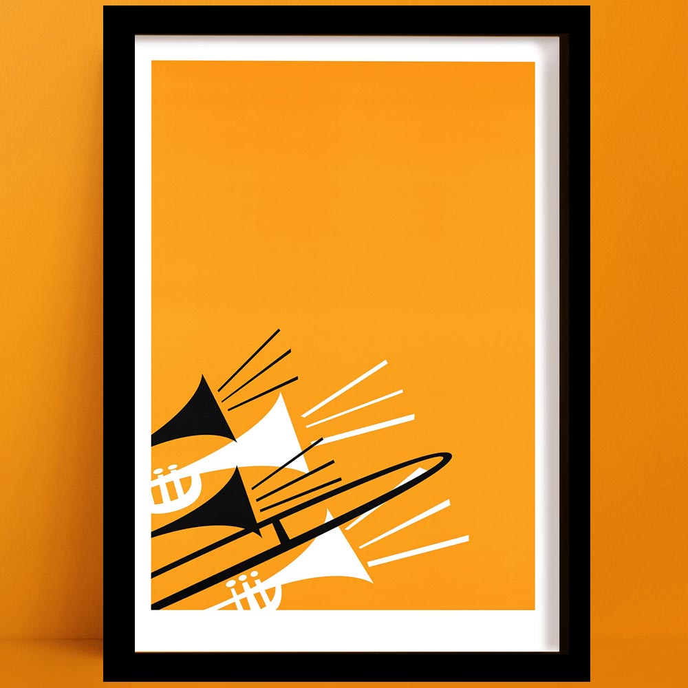 Framed abstract brass instruments print featuring trombones and trumpets in black and white on a vivid orange background