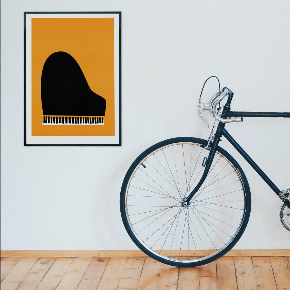 Piano art print on a white wall beside a modern bicycle in a stylish interior setting