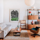 Framed Leeds city print on the wall of a contemporary living space, styled with warm wood tones and modern furniture, bringing in urban personality and vibrancy.