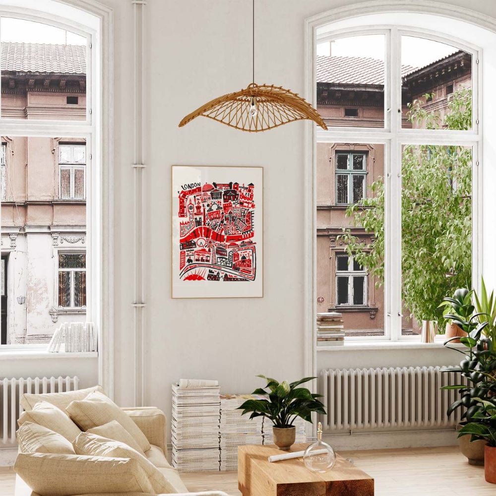 Framed London illustration hanging in a sunlit, plant-filled interior, injecting playful structure and capital-city character into the room.
