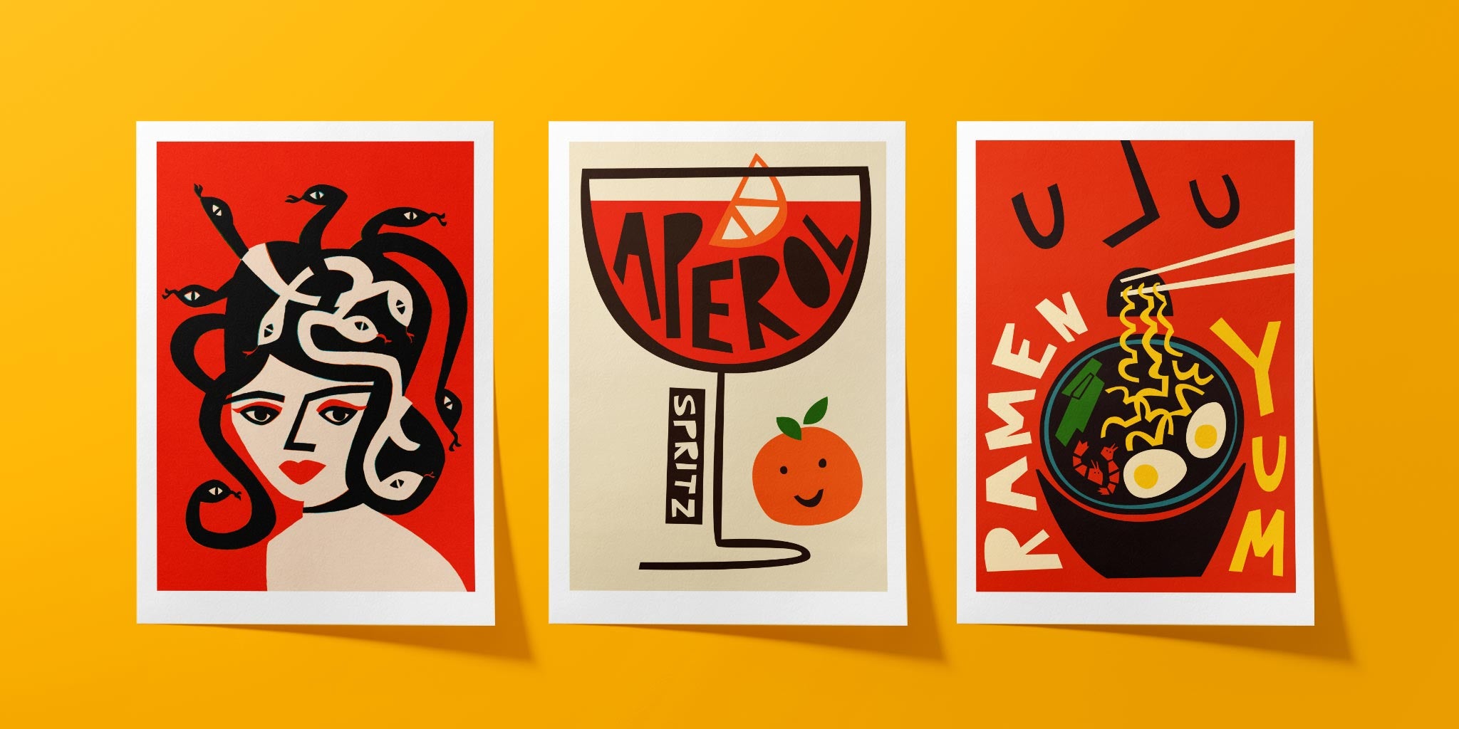 Trio of bold graphic art prints featuring a Medusa portrait, an Aperol Spritz, and a ramen bowl on a yellow backdrop.