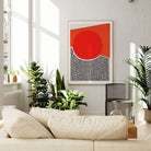The red circle abstract print displayed in a sunlit living space, its bold geometric form adding warmth and graphic impact to a calm and neutral-toned room.