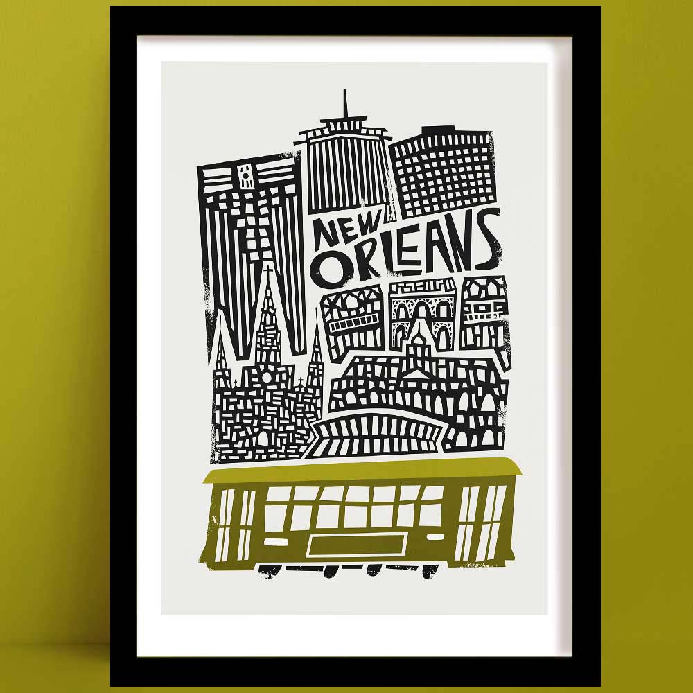 A New Orleans Print with a playful black and white line illustration featuring a skyline, crowned with a classic olive green streetcar, evoking the city’s soulful rhythm