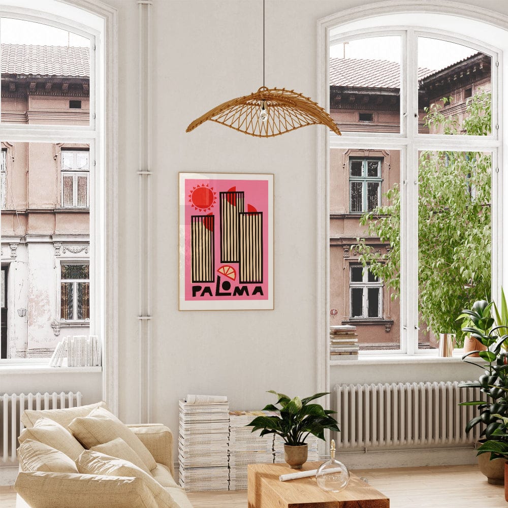 The framed Paloma print hung in a cosy, sunlit living room with soft natural tones, allowing the punchy pinks and linear forms to take centre stage.