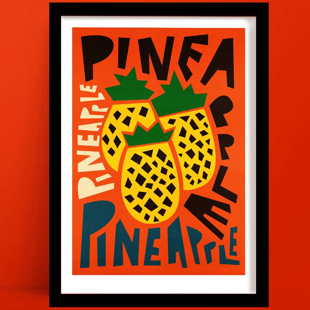 Pineapple print featuring two graphic pineapples surrounded by overlapping “PINEAPPLE” text in bold, varied lettering, framed on a vivid orange wall.
