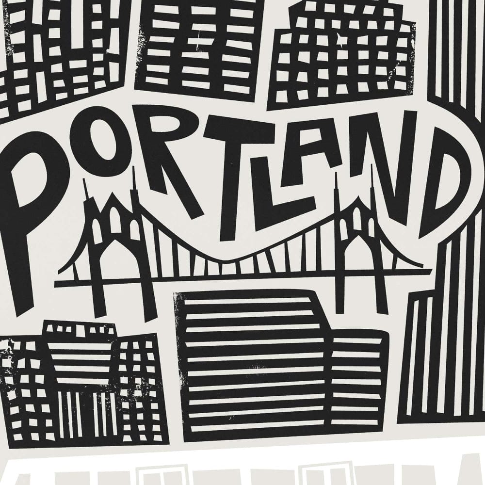 A detailed close-up of the print’s hand-lettered “Portland” text, seamlessly interwoven with the city’s skyline and the graceful curve of the bridge.