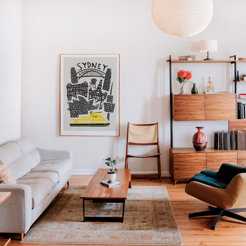 Framed retro Sydney skyline poster brightening a modern living-room gallery wall.