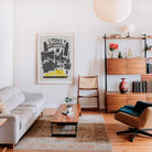 Framed retro Sydney skyline poster brightening a modern living-room gallery wall.