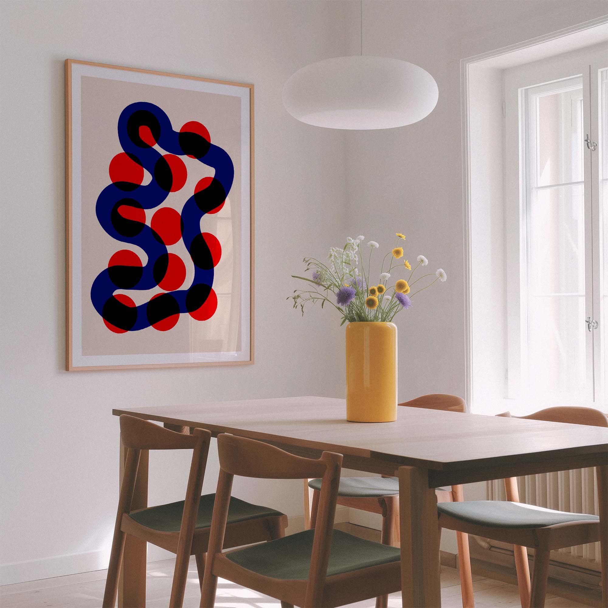 Dining room with a modern abstract painting, yellow vase with flowers, and wooden chairs.