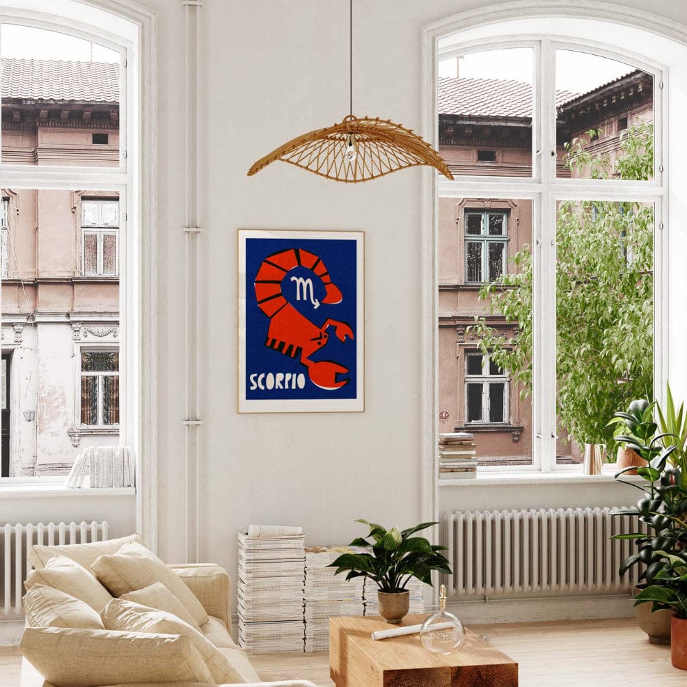 Scorpio print framed in a light-filled room with tall windows, leafy plants, and wooden decor.