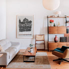The Sheffield art print displayed above a stylish wooden sideboard, bringing a sense of place and urban personality to a mid-century modern lounge interior.