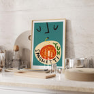 The Spaghetti Yum print perched on a kitchen shelf, bringing a cheeky twist to the space with its rich tomato reds and expressive minimal face lines.