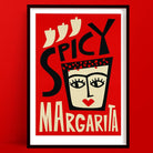 A spicy margarita print with a bold and playful illustration of a stylised margarita glass doubling as a fierce, red-lipped face wearing a crown of chilli peppers, with ‘Spicy Margarita’ in vibrant typography.