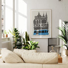 The Stockholm print hanging in a bright, leafy interior with natural light, styled with modern minimalism and a pop of blue.