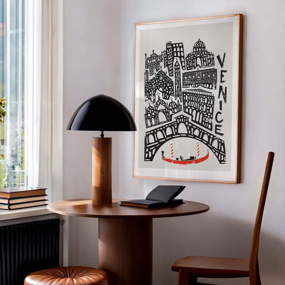 Venice cityscape artwork hanging in a modern reading nook, pairing European romanticism with bold mid-century design energy in a minimalist home.