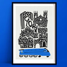 Illustrated York print showing a graphic skyline of historic buildings above a bright blue train, framed on a bold blue wall.