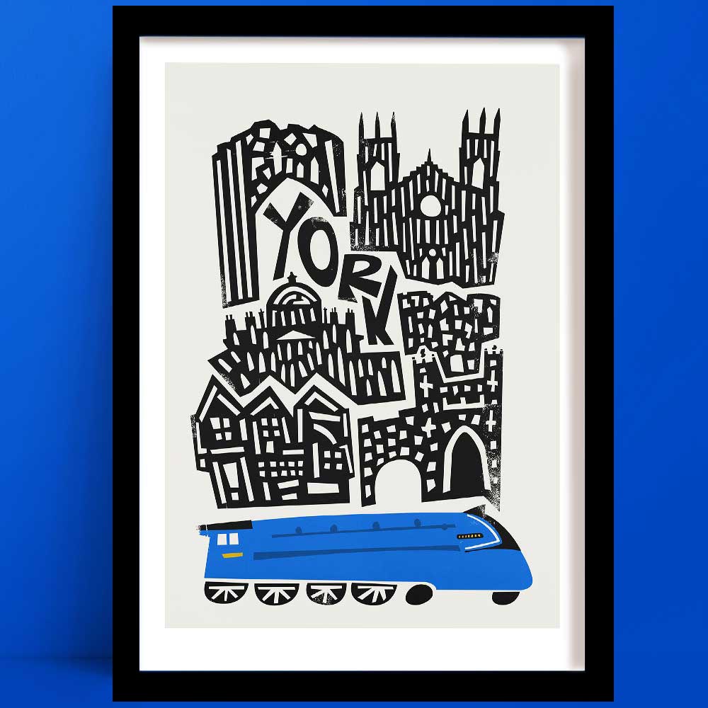 Illustrated York print showing a graphic skyline of historic buildings above a bright blue train, framed on a bold blue wall.