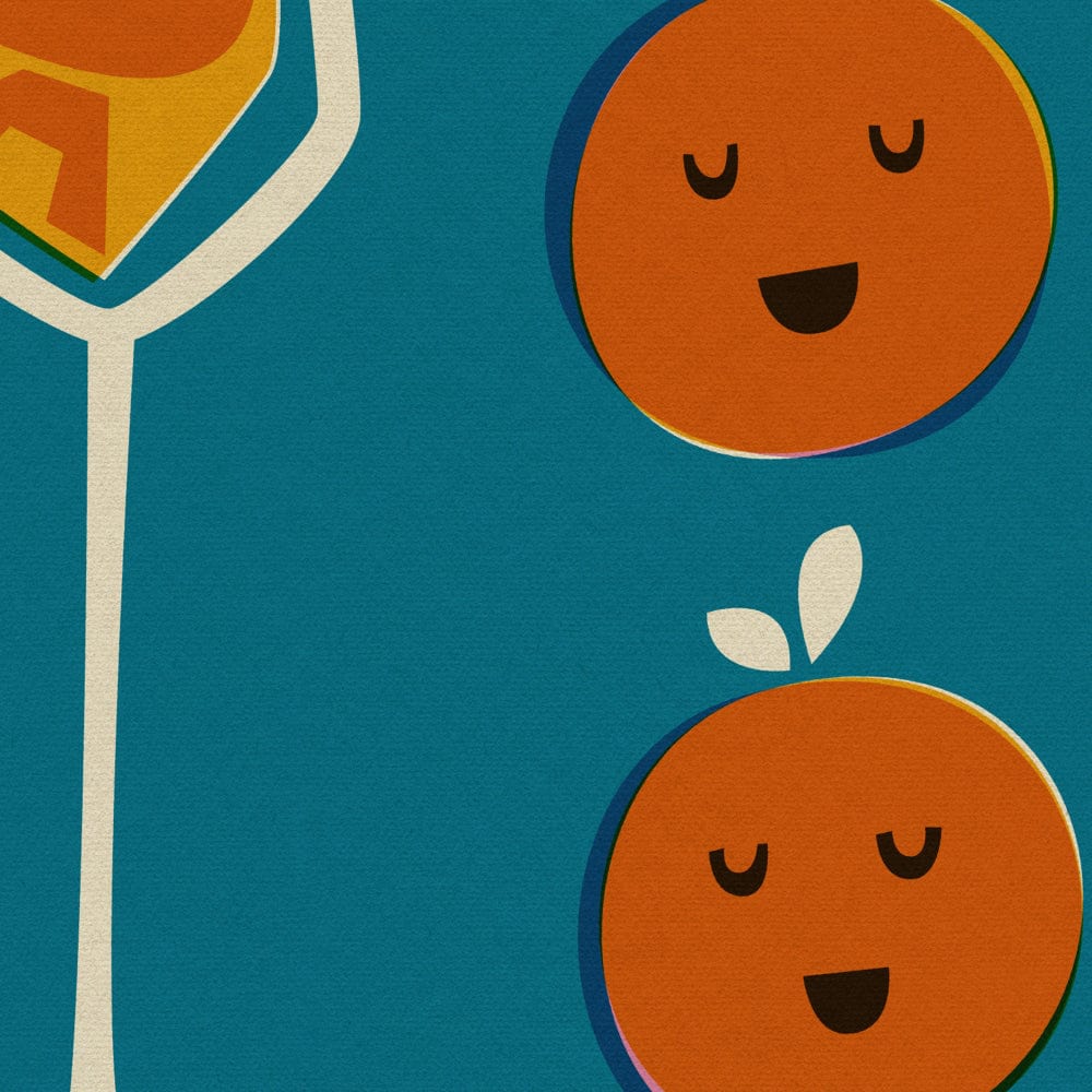 Close-up view showing the playful orange faces and the elegant stem of a champagne flute filled with bubbly orange text.