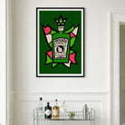 A framed wall art print featuring a stylized green Absinthe bottle illustration with pink, cream, and black graphic elements, hung on a white paneled wall above a glass bar cart with bottles and glasses.