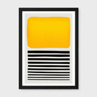 A framed abstract art print featuring a large yellow-orange block on a light gray background with horizontal black stripes below, set in a black frame against a light gray wall.